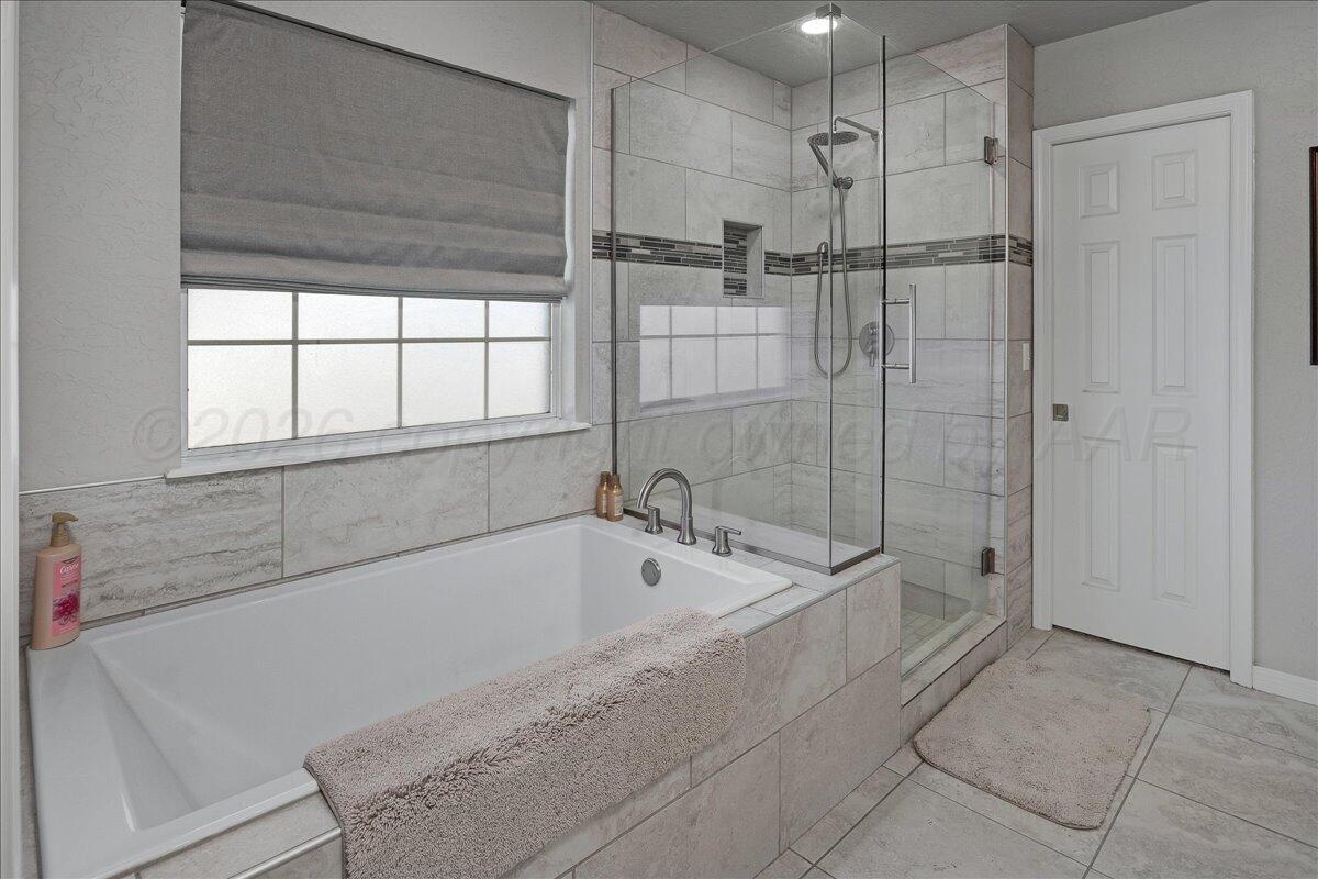 8910 Dove Road Canyon, TX 79015 - Photo 25 of 47 a spacious bathroom with a bathtub and a shower