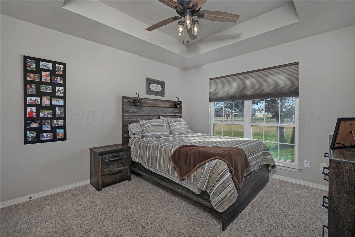 8910 Dove Road Canyon, TX 79015 - Photo 26 of 47 a bedroom with a bed lamps and window