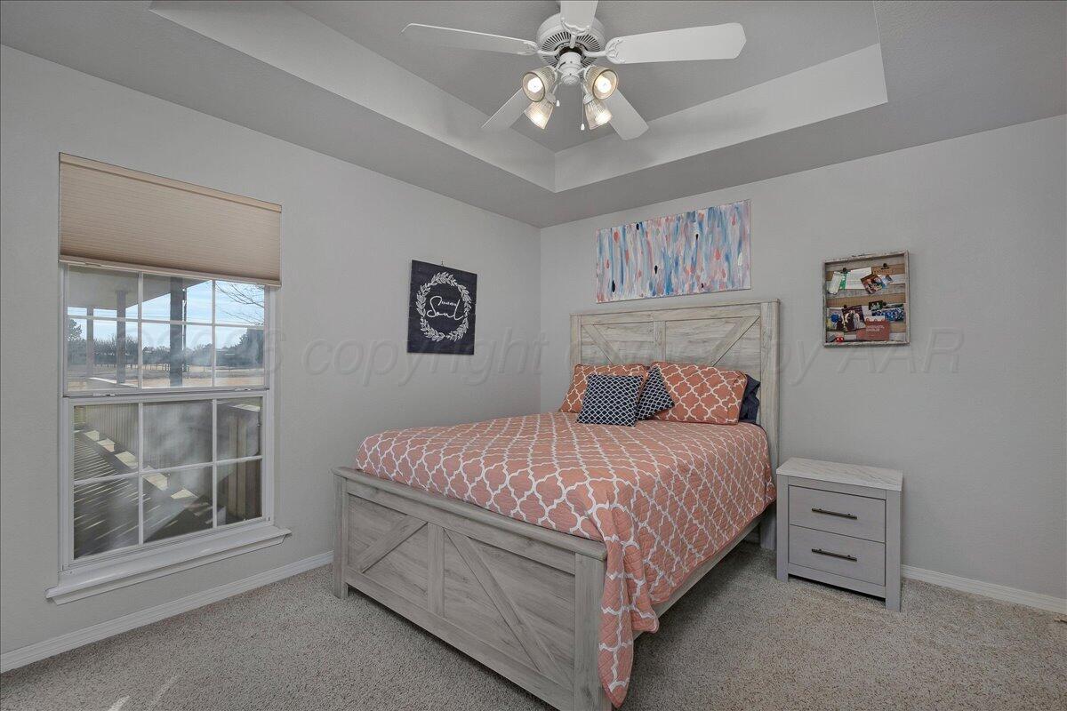 8910 Dove Road Canyon, TX 79015 - Photo 29 of 47 a bedroom with a large bed and a window