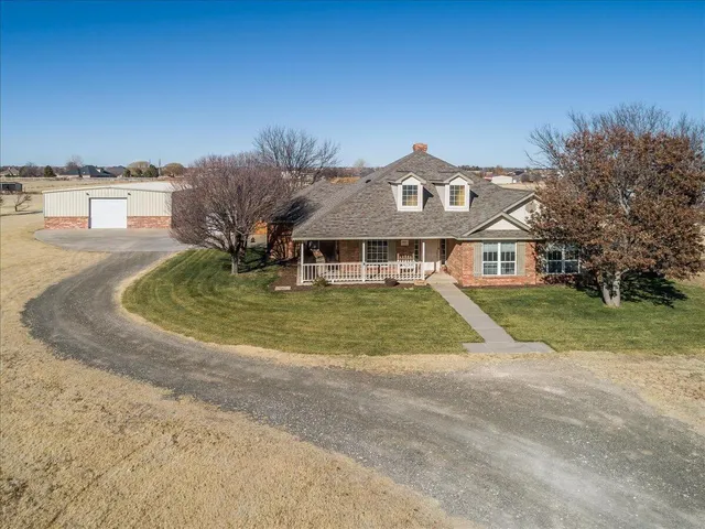 a view of a terrace with lawn chairs