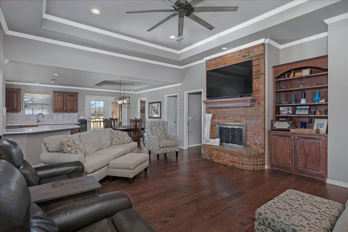 8910 Dove Road Canyon, TX 79015 - Photo 10 of 47 a living room with furniture a flat screen tv and a fireplace