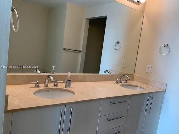 a bathroom with a granite countertop sink a toilet and bathtub