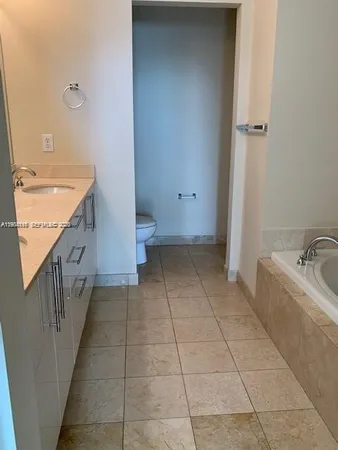 a spacious bathroom with a bathtub