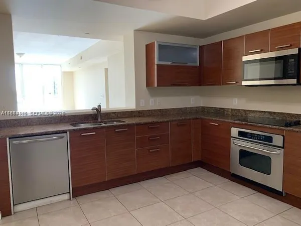 a kitchen with a sink and a stove top oven