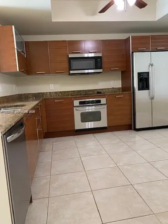 a bathroom with a granite countertop sink a mirror and a bathtub
