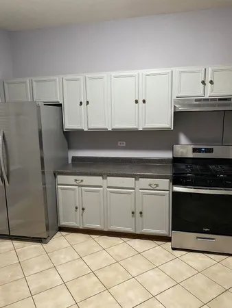 a kitchen with granite countertop a cabinets and steel stainless steel appliances