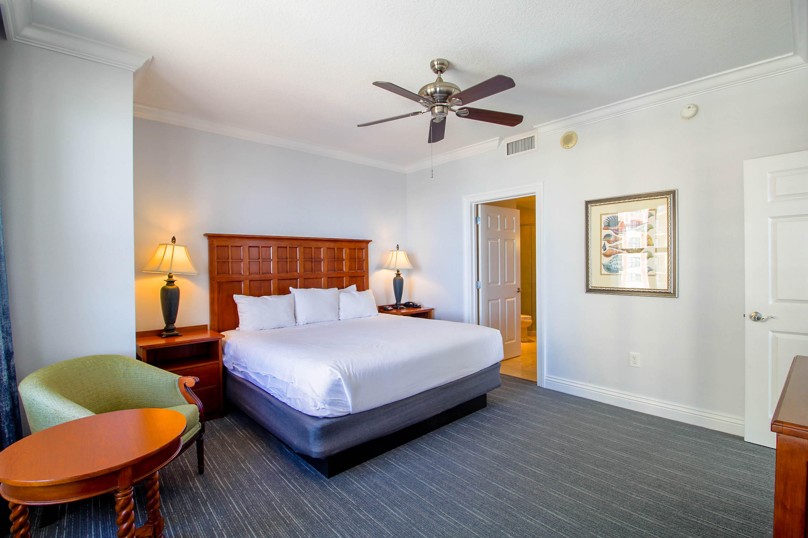 10 Harbor Boulevard, Unit E305E Destin, FL 32541 - Photo 12 of 33 a bedroom with a bed a couch and a potted plant