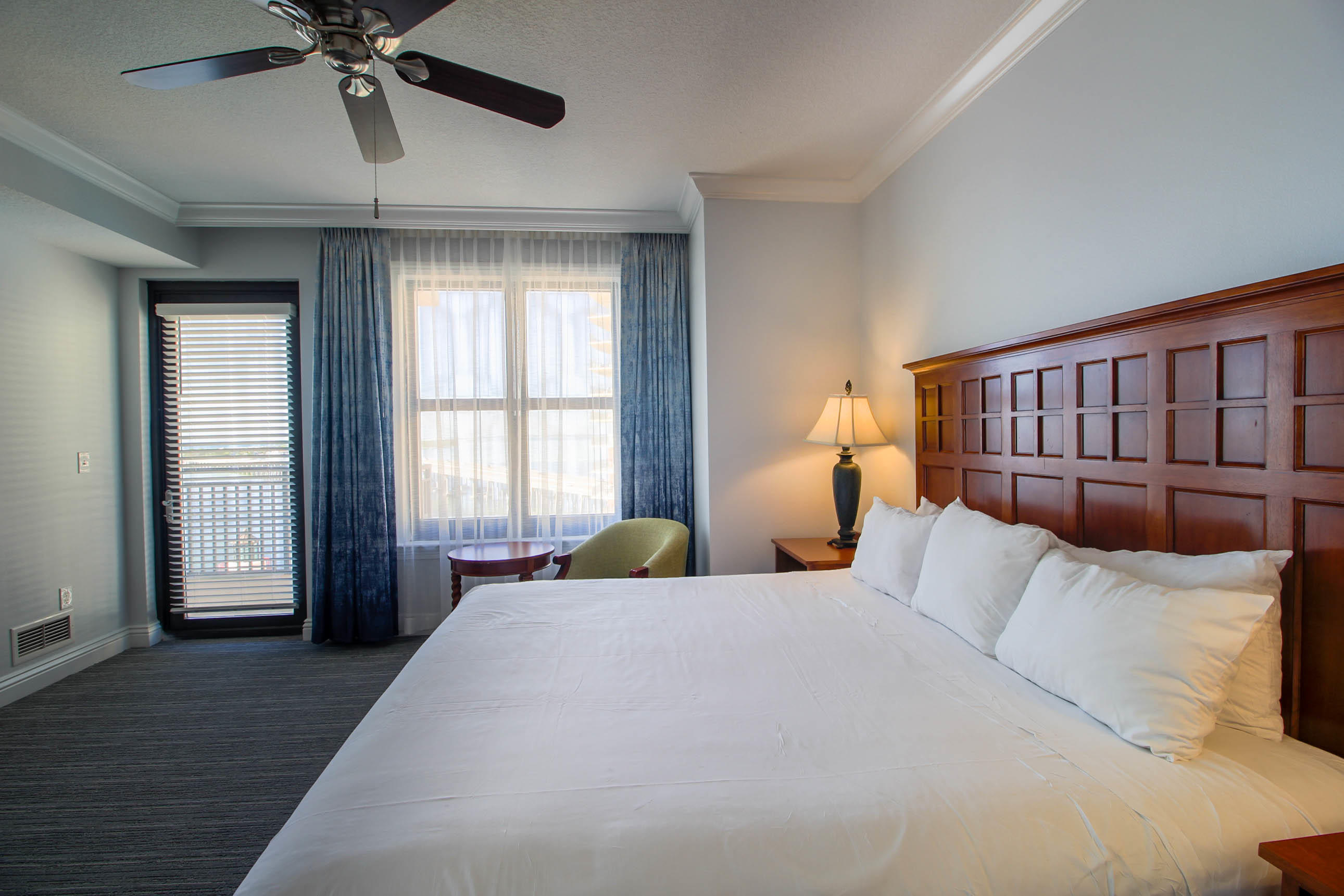 10 Harbor Boulevard, Unit E305E Destin, FL 32541 - Photo 13 of 33 a bedroom with a large bed and a chandelier