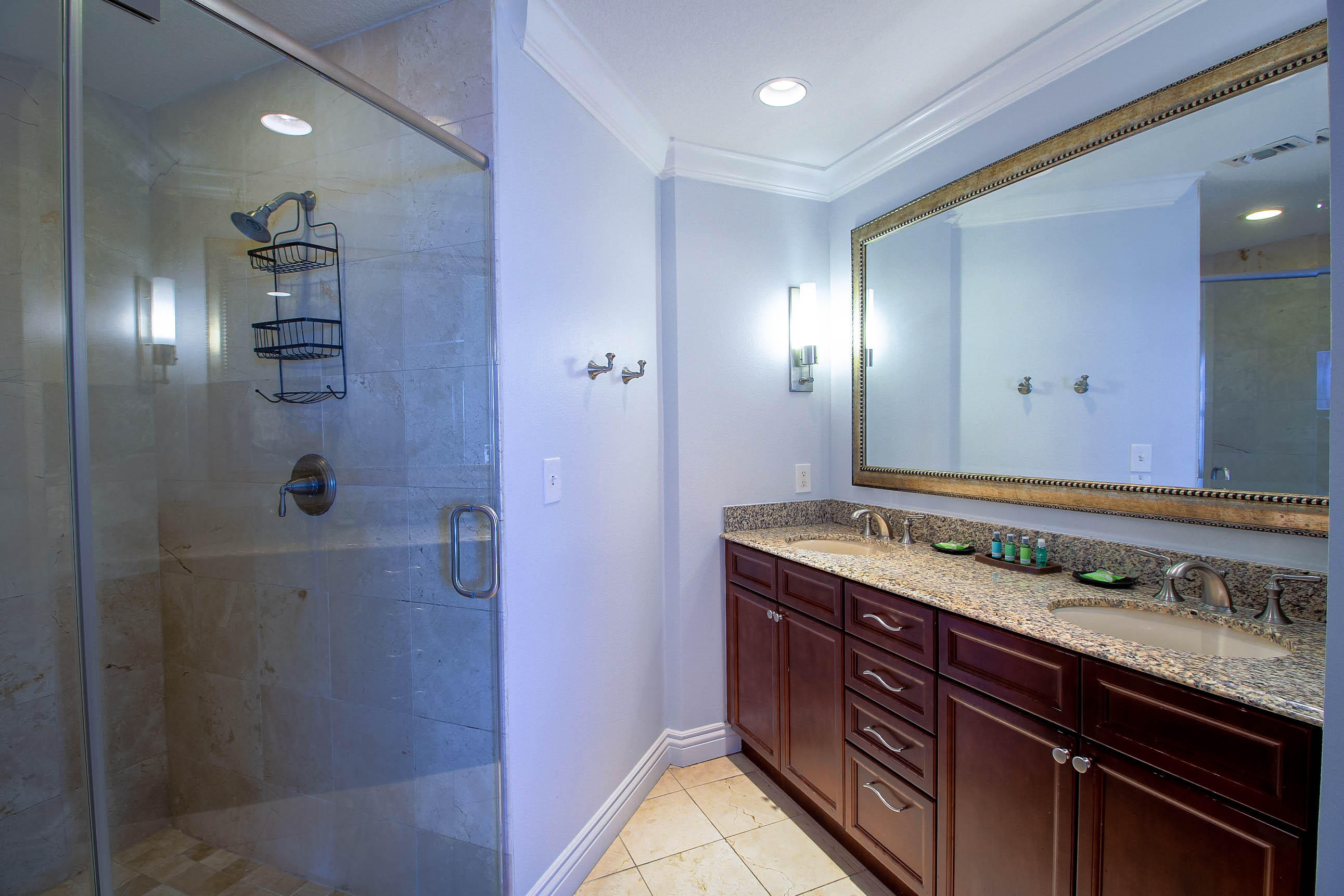 10 Harbor Boulevard, Unit E305E Destin, FL 32541 - Photo 14 of 33 a bathroom with a granite countertop sink a mirror and a shower