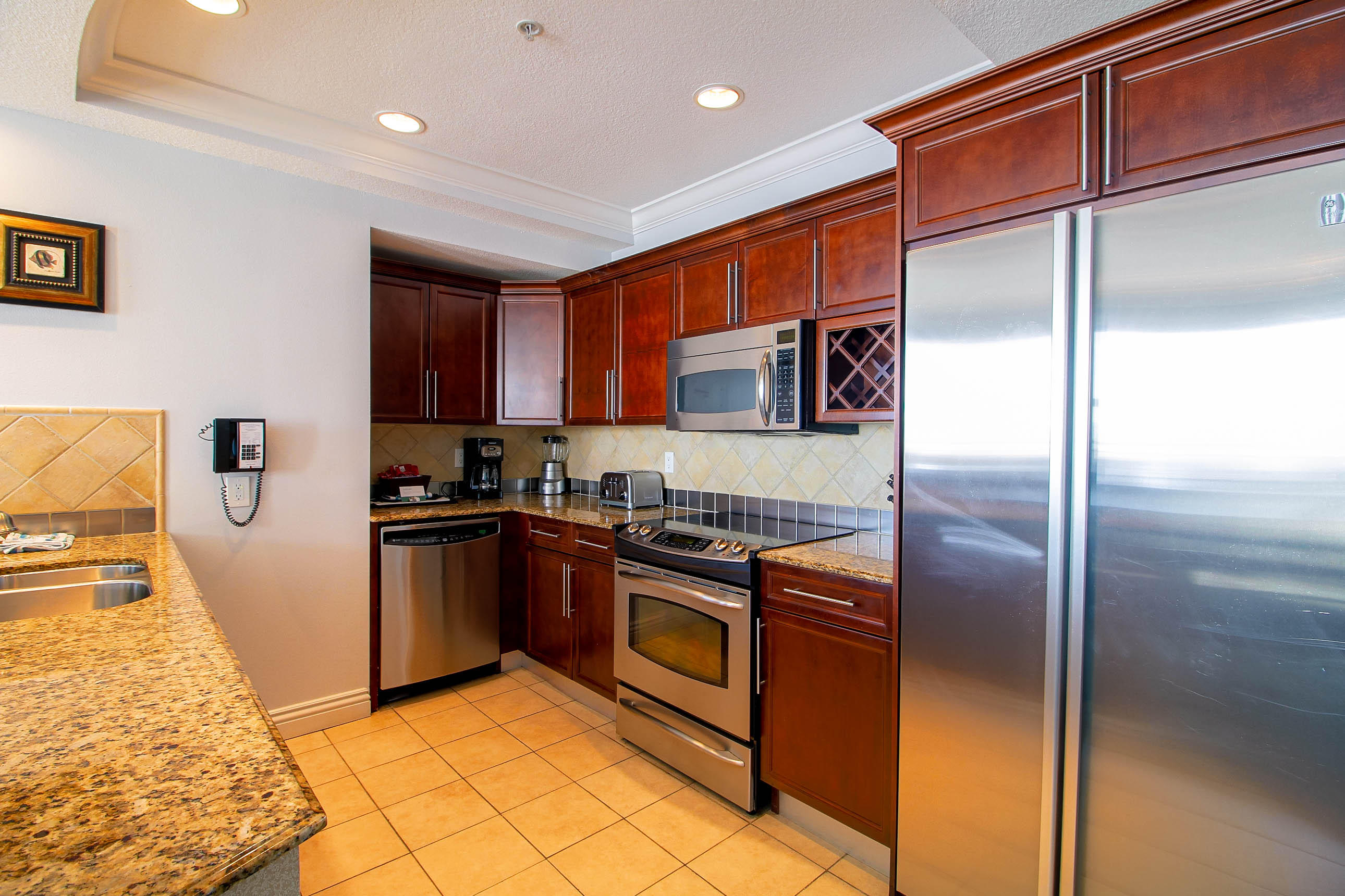 10 Harbor Boulevard, Unit E305E Destin, FL 32541 - Photo 7 of 33 a kitchen with stainless steel appliances granite countertop a refrigerator and a stove