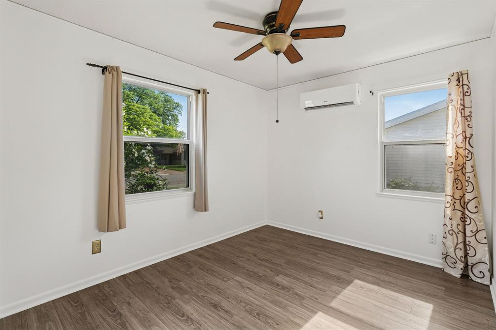 1822 Finley Road Irving, TX 75062 - Photo 23 of 38 a view of empty room with wooden floor and fan