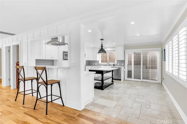 a view of a kitchen with dining room and wooden floor