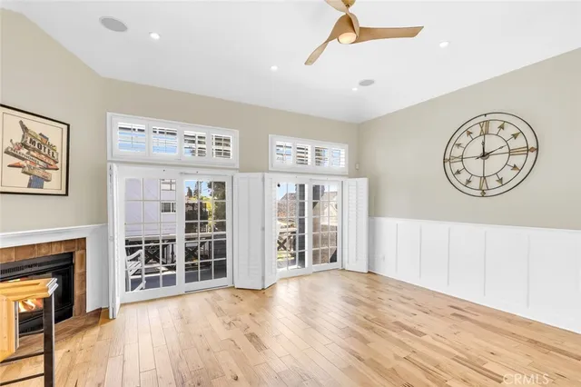 a view of an empty room with furniture wooden floor and a window