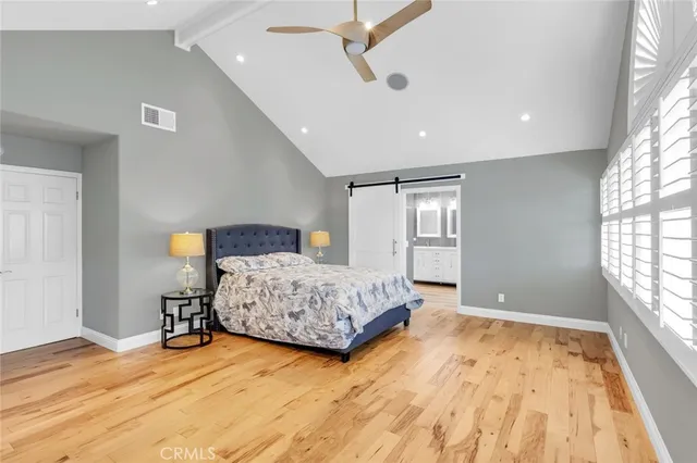 a bedroom with a bed and window