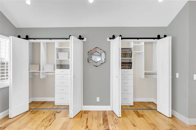 a view of a bedroom with wooden floor and entrance