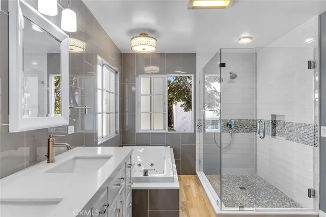 a bathroom with a tub sink and mirror