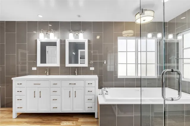 a bathroom with a double vanity sink and mirror