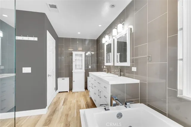 a spacious bathroom with a sink mirror and shower