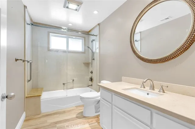 a spacious bathroom with a granite countertop sink toilet and shower