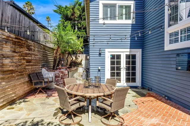 a view of a patio with a table and chairs and potted plants