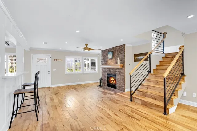 a view of a livingroom with wooden floor and a fireplace
