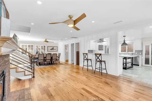 a view of a living room filled with furniture and kitchen view