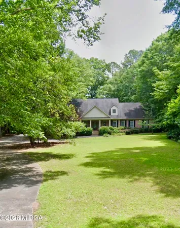 a front view of a house with a garden