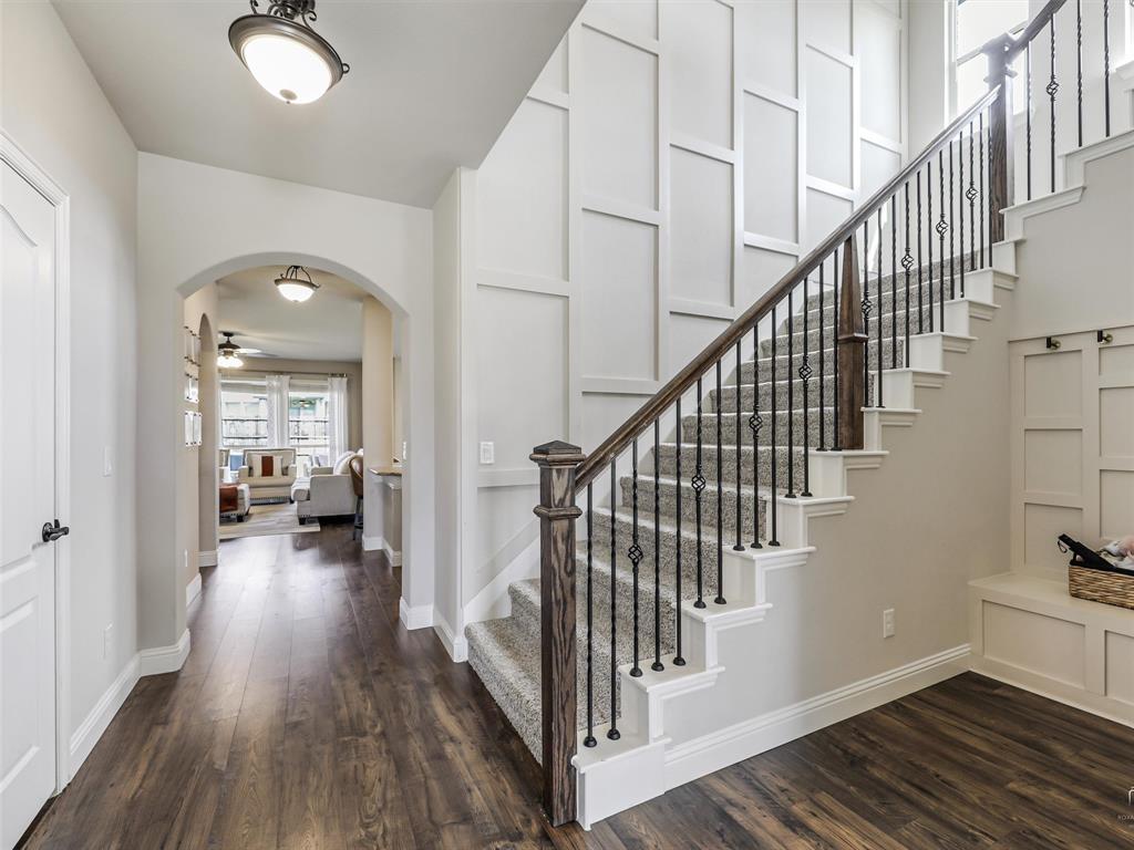 1216 Tree Shadow Lane Anna, TX 75409 - Photo 3 of 37 a view of a hallway with wooden floor and staircase