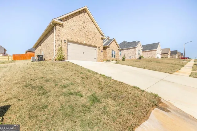 a view of a house with a snow on the road