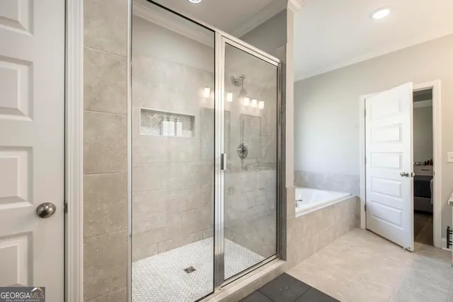 a bathroom with a shower and a bath tub
