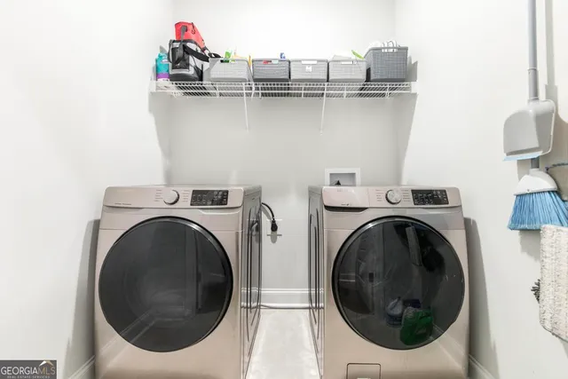 a utility room with sink dryer and washer