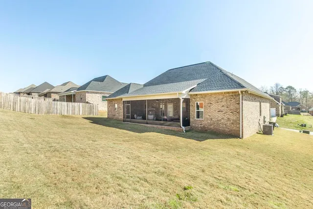 a view of a house with a yard and sitting area