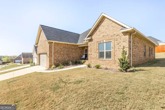 a view of a house with snow on the road