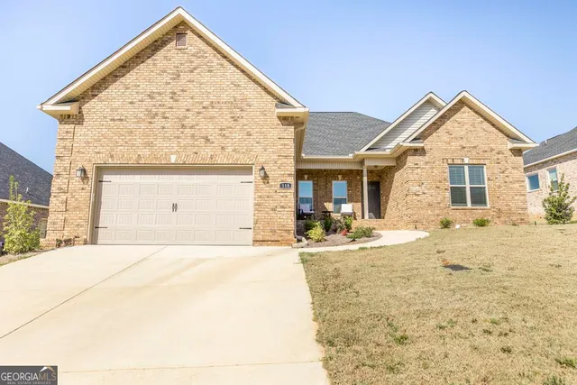 a view of white house with a yard
