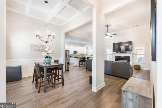 a view of a dining room with furniture wooden floor and chandelier