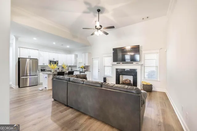 a living room with furniture a fireplace and a flat screen tv