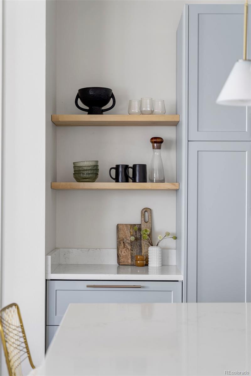 2908 Ironton Street Denver, CO 80238 - Photo 5 of 30 a shelf with books and knick knacks on it