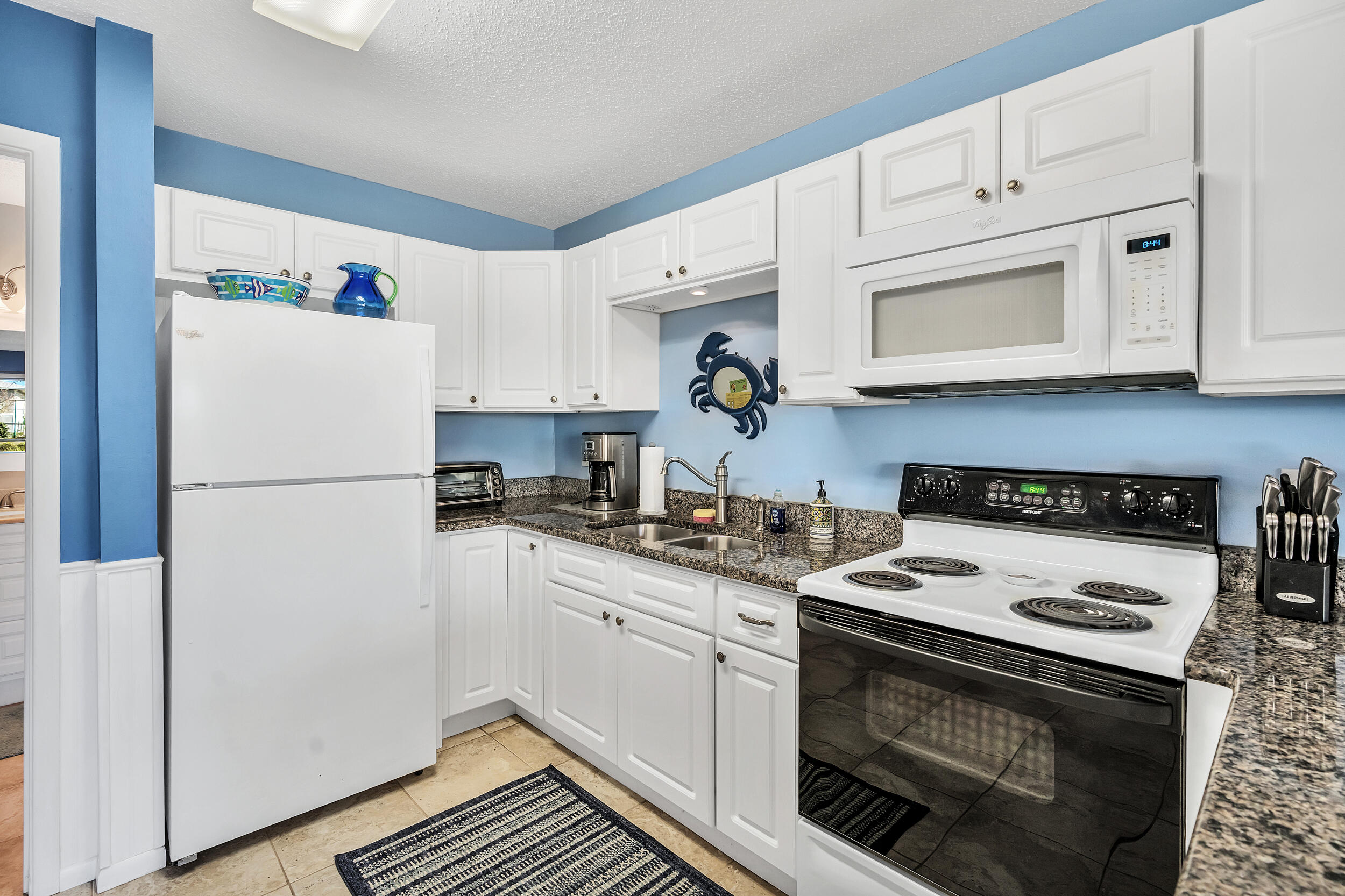 3799 East County Highway 30A, Unit C8 Santa Rosa Beach, FL 32459 - Photo 15 of 49 a kitchen with cabinets appliances a sink and a counter top space
