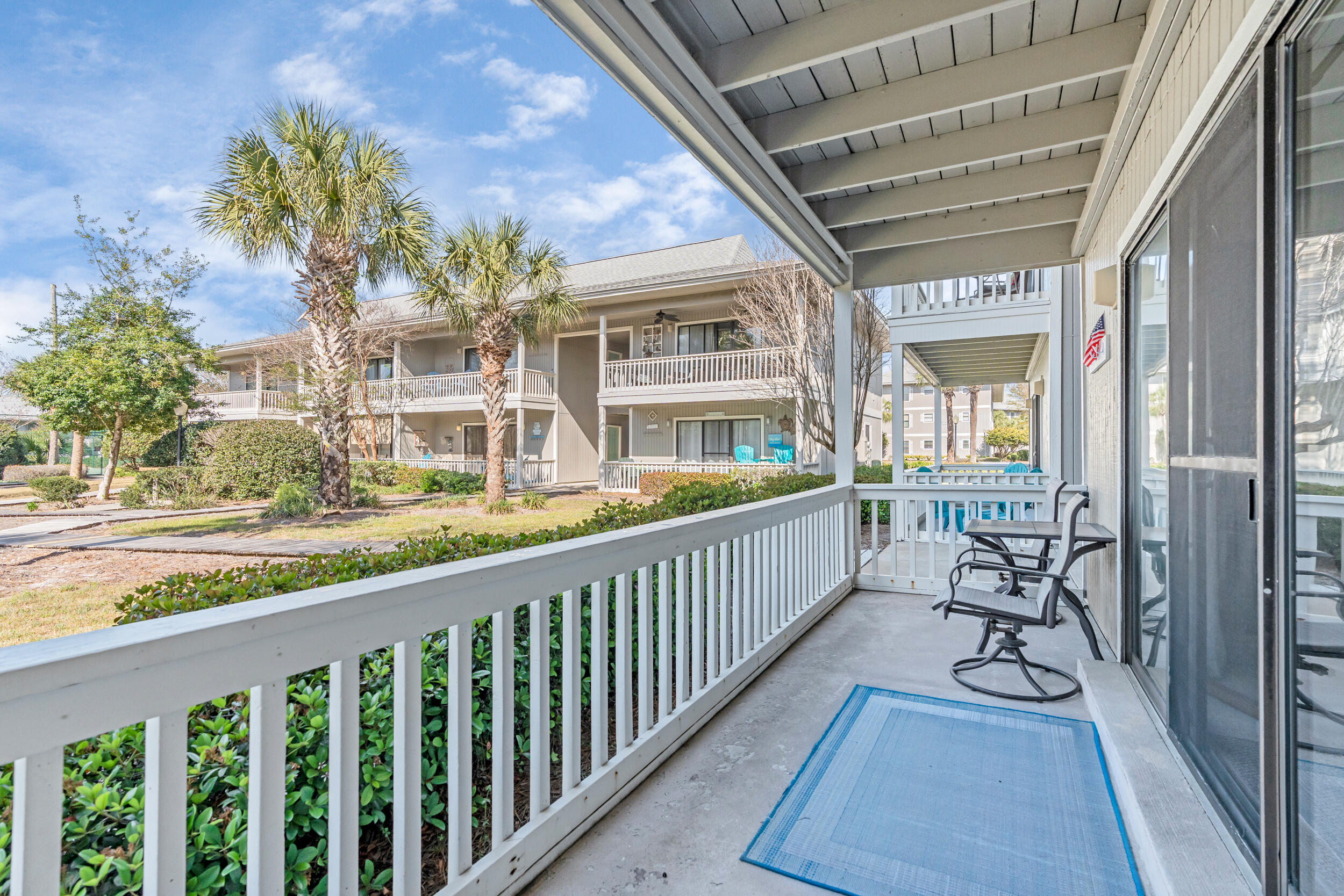3799 East County Highway 30A, Unit C8 Santa Rosa Beach, FL 32459 - Photo 5 of 49 a view of a balcony with chairs and wooden floor