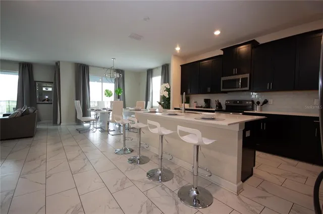 a living room with patio furniture and a potted plant