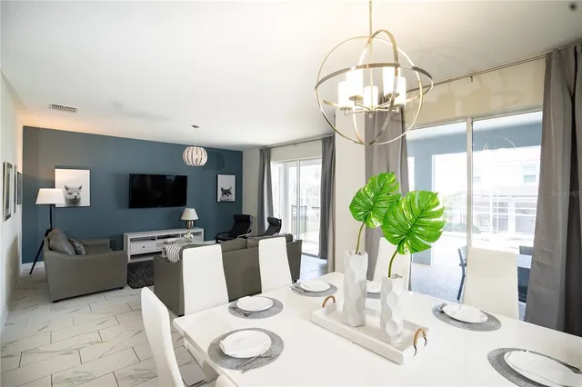 a living room with furniture and a kitchen view