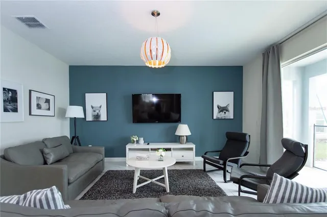 a living room with furniture fireplace and a flat screen tv