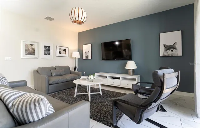 a living room with furniture and a flat screen tv