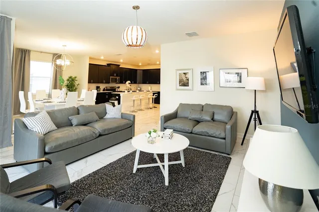 a bedroom with a bed and painting on the wall