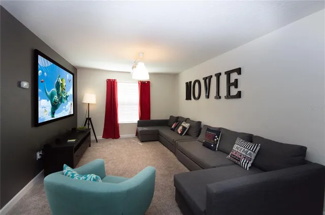 a bedroom with a large bed and a lamp