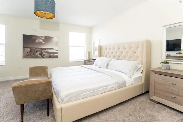 a bedroom with a bed and a painting on the wall