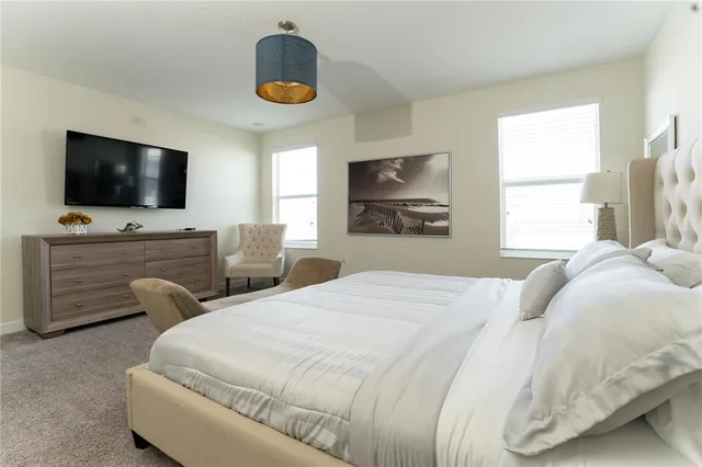 a bedroom with a bed and a painting on the wall