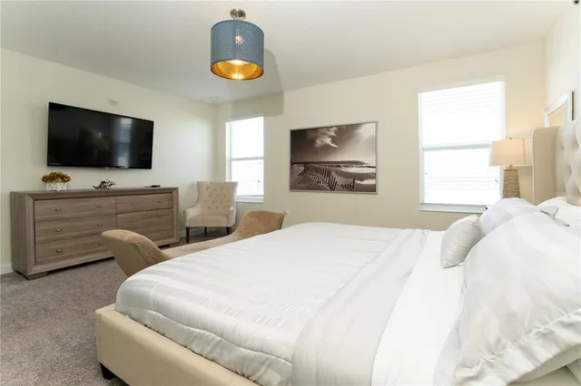 a bedroom with a bed and painting on the wall