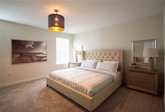 a bedroom with a bed and a chandelier