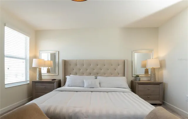 a bedroom with two beds and a chandelier